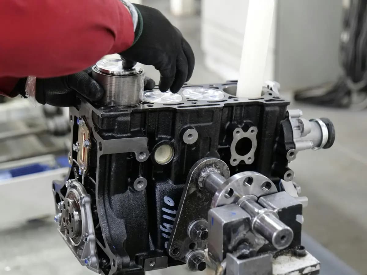 Close-up of an engine block being assembled in a workshop