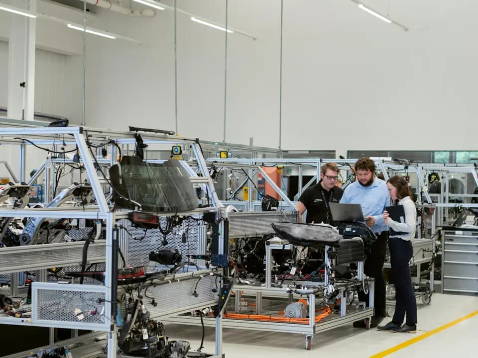 Engineers comparing production details during a factory inspection review