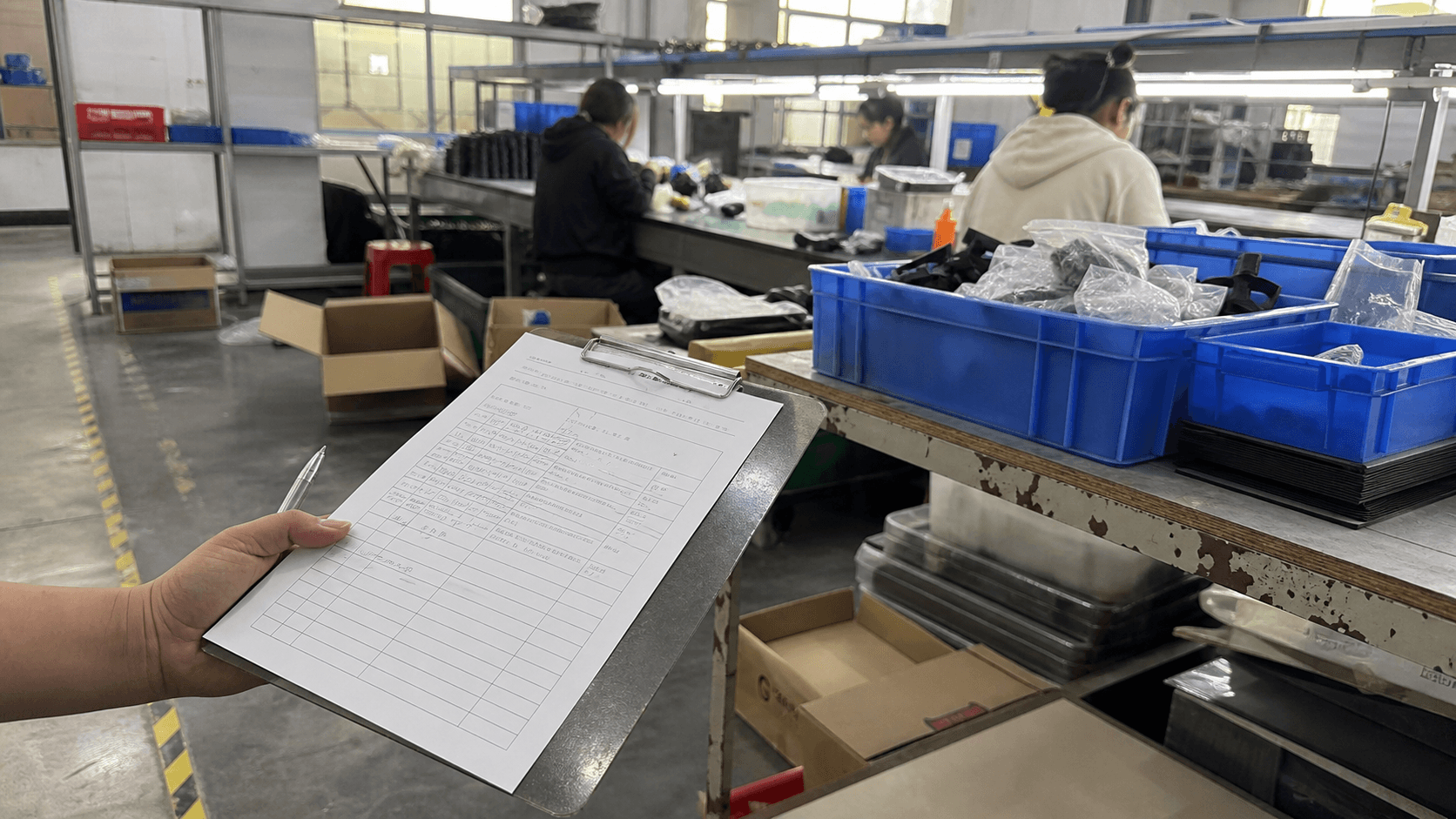 Clipboard view of a modest factory assembly line during supplier review
